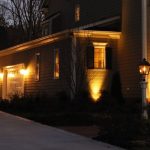 Residential house with outdoor lighting, garage, and landscaped shrubs from Aptus Home Services.