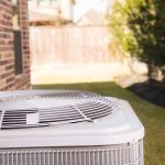 Air conditioning unit outdoors, showcasing maintenance importance for energy efficiency and reliability in HVAC systems.