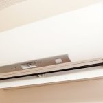 Ductless mini split air conditioner unit mounted on a wall, showcasing energy-efficient indoor climate control technology for targeted room cooling and heating.