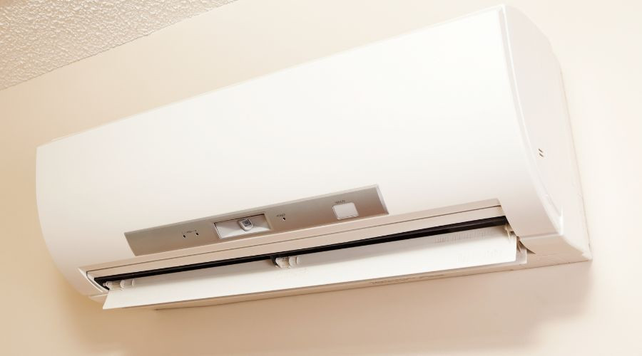 Ductless mini-split air conditioner mounted on a wall, showcasing modern design for efficient indoor climate control.