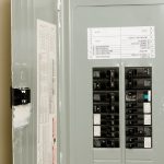Electrical panel with circuit breakers, illustrating potential signs of wear and the importance of professional electrical services for safety and maintenance.
